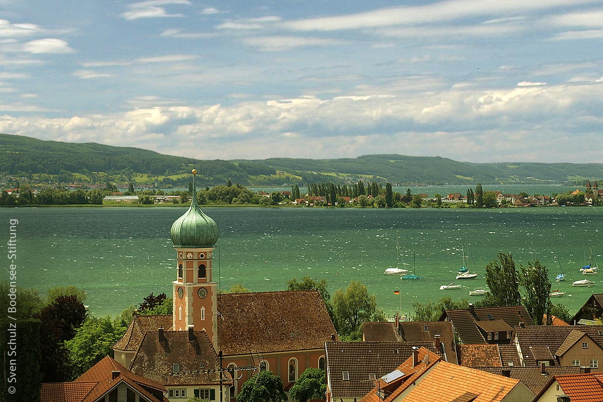 Blick von Allensbach – über die evangelische Gnadenkirche hinweg – auf die Reichenau, im Hintergrund das Schweizer Ufer am Untersee.